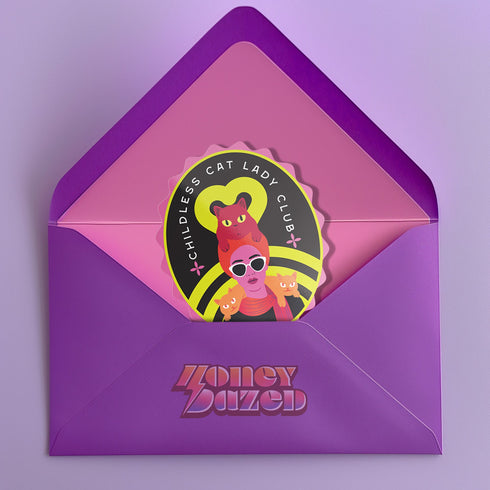 Vibrant oval sticker reading "Childless Cat Lady Club". Features cartoon woman with sunglasses surrounded by cats. Bold retro design in pink, yellow, and red.